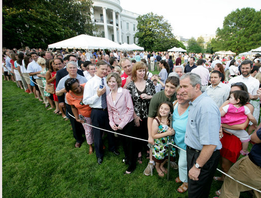 President George W. Bush poses for photos with some of the hundreds of guests attending the annual Congressional Picnic on the South Lawn of the White House, Thursday evening, June 5, 2008, for members of Congress and their families. White House photo by Chris Greenberg