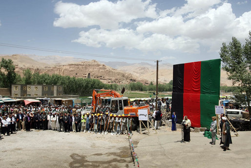 Mrs. Laura Bush, to the right of the podium, is introduced June 8, 2008 by Governor Habiba Sarabi as workmen prepare to break ground for the Bamiyan Bazaar road project in Afghanistan. White House photo by Shealah Craighead