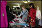 Mrs. Laura Bush greets local businesswomen as she tours the marketplace of the Arzu and Bamiyan Women’s Business Association on June 8, 2008 in Afghanistan. The carpets, embroidery and other Afghan wares are all made by women. White House photo by Shealah Craighead