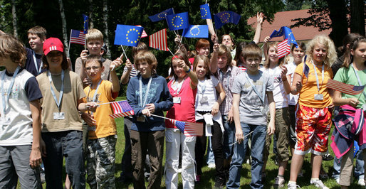 Young children wave American and European Union flags as they wait for President George W. Bush as he participates in a United States - European Union Working Lunch Tuesday, June 10, 2008, at the Brdo Congress Center in Kranj, Slovenia. White House photo by Chris Greenberg