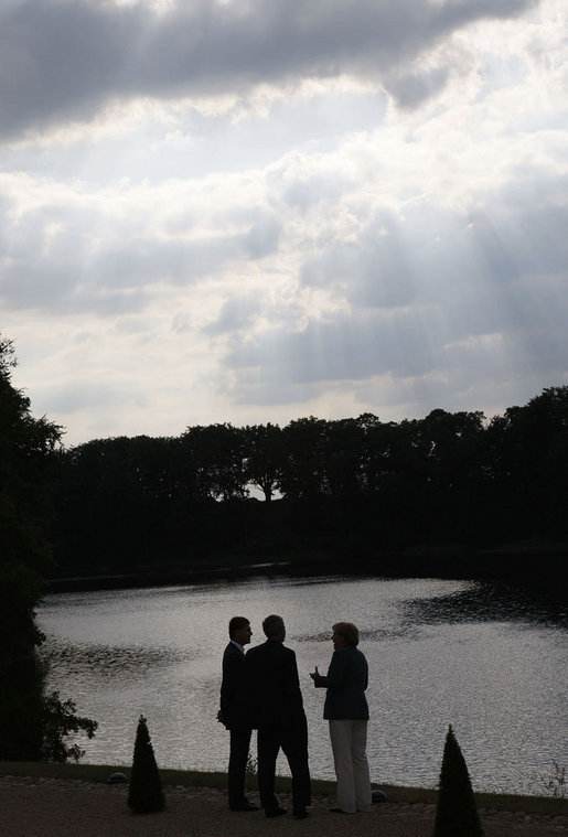 President George W. Bush talks with German Chancellor Angela Merkel and her husband, Joachim Sauer, Tuesday, June 10, 2008, during an early evening stroll near a lake on the grounds of the government guest house in Meseberg, Germany. White House photo by Eric Draper