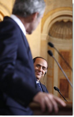 A smiling Italian Prime Minister Silvio Berlusconi listens as President George W. Bush addresses reporters at their joint press availability Thursday, June 12, 2008, at the Villa Madama in Rome. White House photo by Eric Draper