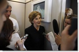 Mrs. Laura Bush speaks with members of the press June 13, 2008 aboard Air Force One, as she and President Bush travel from Rome to Paris on their multi-city European visit.  White House photo by Eric Draper