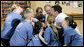 President George W. Bush participates in a basketball game huddle with members of the Peace Players basketball team and their coach Monday. June 16, 2008, during a visit to the Lough Integrated Primary School in Belfast, Ireland. White House photo by Chris Greenberg