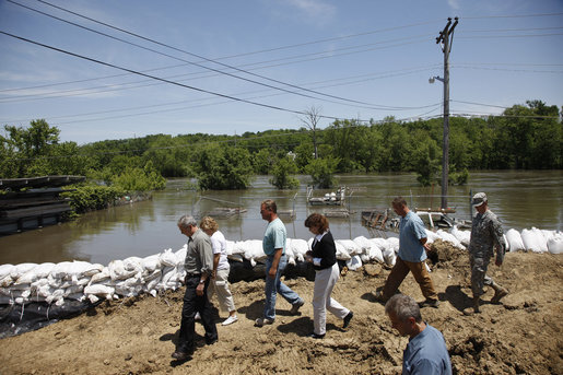 President George W. Bush tours Streb Construction Company in Iowa City, Iowa Thursday, June 19, 2008, as sandbags hold back the flooding Iowa River waters. White House photo by Eric Draper