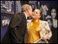 President George W. Bush gives a kiss on the cheek to Edith Espinoza, Administrative Assistant, Chicano Federation, after introducing him at the Office of Faith-Based and Community Initiatives National Conference Thursday, June 26, 2008, in Washington, D.C. The President opens his remarks, "How beautiful was that? From being a homeless mother of two to introducing the President of the United States. There has to be a higher power. I love being with members of the armies of compassion, foot soldiers in helping make America a more hopeful place. Every day you mend broken hearts with love. You mend broken lives with hope. And you mend broken communities with countless acts of extraordinary kindness." White House photo by Chris Greenberg