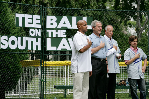 President George W. Bush is joined during the playing of the National Anthem by Roberto Clemente Jr., left, son of Hall of Famer Roberto Clemente; Angel Macias, who in 1957 became the only player to pitch a perfect game in Little League World Series history, and actor Jake T. Austin, right, who will portray Macias in an upcoming film about that game, seen together Monday, June 30, 2008, at Tee Ball on the South Lawn at the White House. White House photo by Chris Greenberg