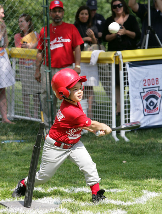 A player for the Cramer Hill Little League Rex Sox of Camden, N.J. hits the ball during the season opening game of the 2008 Tee Ball on the South Lawn Monday, June 30, 2008, on the South Lawn of the White House playing against the Jose M. Rodriguez Little League Angels of Manati, Puerto Rico. White House photo by Chris Greenberg
