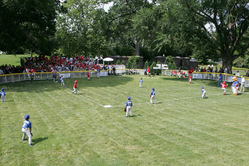 A view from the outfield on the South Lawn of the white House shows the opening game of the the 2008 Tee Ball season in action Monday, June 30, 2008, between the Cramer Hill Little league Red Sox of Camden, N.J., and the Jose M. Rodriguez Little League Angels of Manati, Puerto Rico. White House photo by Joyce N. Boghosian