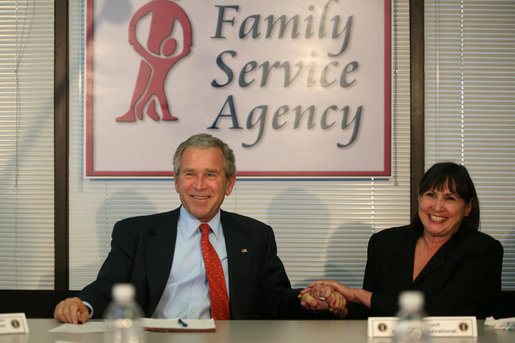 President George W. Bush holds the hand of Patty Couch during a roundtable discussion on Housing Counseling, Tuesday, July 1, 2008 at Family Service Agency Inc. in North Little Rock, Arkansas. White House photo by Joyce N. Boghosian