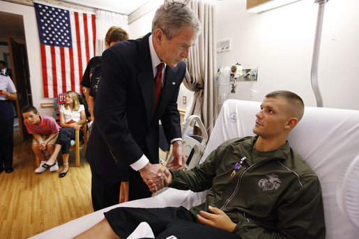 President George W. Bush shakes hands after awarding a Purple Heart medal to U.S. Marine Corps Pfc. Jacob Brittain of Frankfort, Tenn., Thursday, July 3, 2008, at the National Naval Medical Center in Bethesda, Md. White House photo by Eric Draper