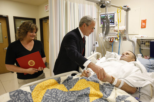 President George W. Bush meets with U.S. Marine Corps Sgt. Maj. Patrick Wilkinson and his wife, Jennifer, of Temecula, Calif., Thursday, July 3, 2008, at the National Naval Medical Center in Bethesda, Md., where President Bush presented Wilkinson with a Purple Heart medal. White House photo by Eric Draper