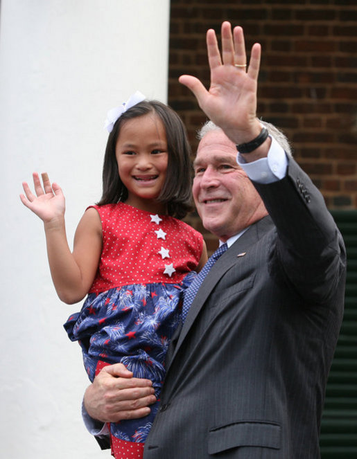 President George W. Bush holds Julia White Freeman, formerly of China, after she took the Oath of Citizenship at Monticello's 46th Annual Independence Day Celebration and Naturalization Ceremony Friday, July 4. 2008, in Charlottesville, VA. White House photo by Joyce N. Boghosian