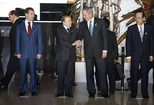President George W. Bush shares a moment with President Abdelaziz Bouteflika of Algeria, as they stand for a photo opportunity with Africa Outreach Representatives Monday, July 7, 2008, at the Windsor Hotel Toya Resort and Spa in Toyako, Japan. With them are President Dmitriy Medvedev, left, of Russia, and Prime Minister Yasuo Fukuda of Japan, host of the 2008 G-8 Summit. White House photo by Eric Draper