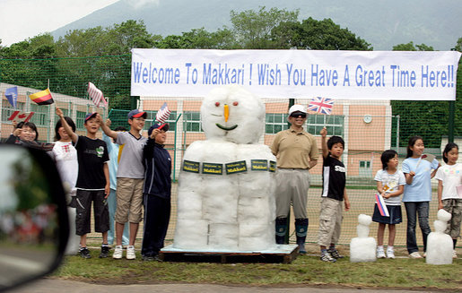Flag-waving youngsters and a snowman welcome the G-8 Spouses to Makkari Tuesday, July 8, 2008, where they visited a farmer's market and participated in a luncheon hosted by Mrs. Kiyoko Fukuda, spouse of Japan's Prime Minister Yasuo Fukuda, host of the 2008 G-8 Summit. White House photo by Shealah Craighead