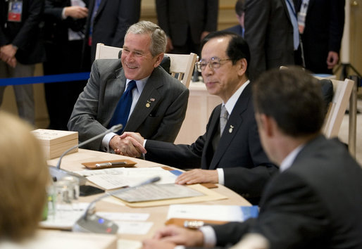 President George W. Bush exchanges handshakes with Prime Minister Yasuo Fukuda of Japan, Tuesday, July 8, 2008, as the G-8 leaders began their morning working session at the Windsor Hotel Toya Resort and Spa in Toyako, Japan. White House photo by Eric Draper