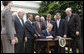 President George W. Bush, joined by members of his Cabinet and members of Congress, signs the FISA Amendments Act of 2008 Thursday, July 10, 2008, in the Rose Garden at the White House. White House photo by Eric Draper