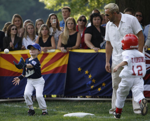 John Cloer, age 7, from Sierra Madre, Calif., makes the catch as West Virginia's Brody Kehrer, age 5, races to beat him to the base during All-Star tee ball action on the White House South Lawn on July 16, 2008. One child represented each state and the District of Columbia and teams were divided into four regions with California, represented on the Western team and West Virginia in the Southern team. White House photo by Eric Draper