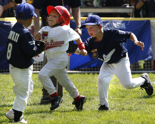 Reggie Graff, right, age 6, from St. George, Utah, tags North Carolina's Avery Shane, age 5, center, as Hawaii's Joshua Miyazawa, age 5, watches during All-Star tee ball action on July 16, 2008 on the South Lawn of the White House. Shane, from Rutherfordton, N.C., was on the Southern team and Graff and Miyazawa, from Honolulu were on the Western team. Two other teams, representing the Central and Eastern sections of the country, played and one child represented each state. President George W. Bush and Mrs. Laura Bush watched the action from a bleachers set up on the grounds for the kids' families. White House photo by Eric Draper
