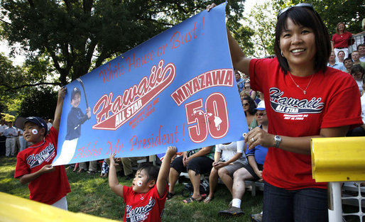 Tee Ball All-Star Joshua Miyazawa, age 5, gets a boost from his Hawaiian fan club as he plays on the South Lawn of the White House on July 16, 2008. The banner also holds a greeting for President George W. Bush, who watched the demonstration of teamwork and discipline from a nearby bleachers with Mrs. Laura Bush and the families of the children attending. One child represented each state and the District of Columbia and the teams were divided into Western, Central, Southern and Eastern teams, with Joshua playing on the Western Team. White House photo by Eric Draper