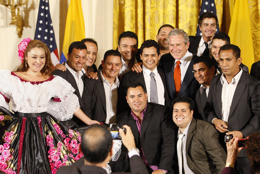 President George W. Bush poses for photos with entertainers Jorge Celedon, Jimmy Zambrano and their performance group during the celebration of Colombian Independence Day Tuesday, July 22, 2008, in the East Room of the White House. White House photo by Eric Draper