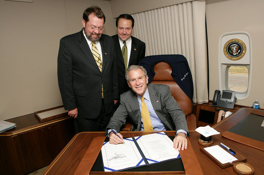 President George W. Bush is joined by Rep. Steven LaTourette, R-OH, left, and Rep. Patrick Tiberi, R-OH, at the signing of S.2766, The Clean Boating Act of 2008, Tuesday, July 29, 2008, aboard Air Force One on the flight from Euclid, Ohio to Washington, D.C. White House photo by Chris Greenberg