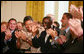 HIV/AIDS activist Mohamed Kalyesubula of Uganda waves to acknowledge the applause of guests, joined by fellow HIV/AIDS activist nurse Agnes Nyamayarwo of Uganda, left, both honored by President George W. Bush Wednesday, July 30, 2008 in the East Room of the White House, at the signing ceremony of H.R. 5501, the Tom Lantos and Henry J. Hyde United States Global Leadership Against HIV/AIDS, Tuberculosis and Malaria Reauthorization Act of 2008. White House photo by Joyce N. Boghosian