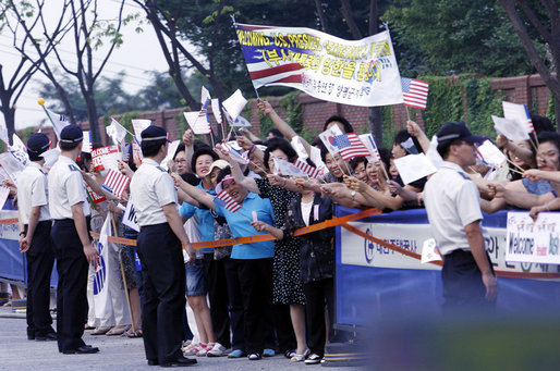 Crowds cheer and wave flags as the motorcade of President George W. Bush and Mrs. Laura Bush passes Tuesday, Aug. 5, 2008, following President Bush's arrival to Seoul, South Korea. White House photo by Eric Draper