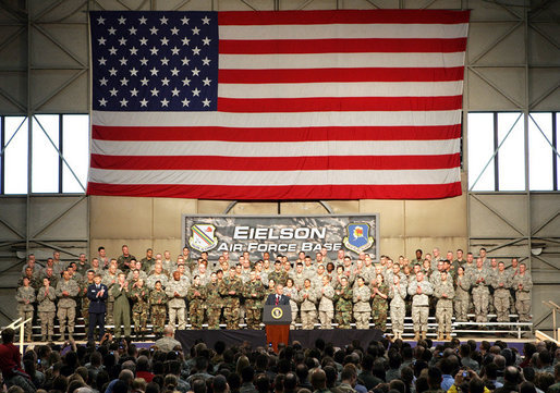 With an American flag as a backdrop, President George W. Bush addresses military personnel Monday, Aug. 4, 2008, during a stop in Alaska at Eielson Air Force Base, en route to South Korea. White House photo by Chris Greenberg