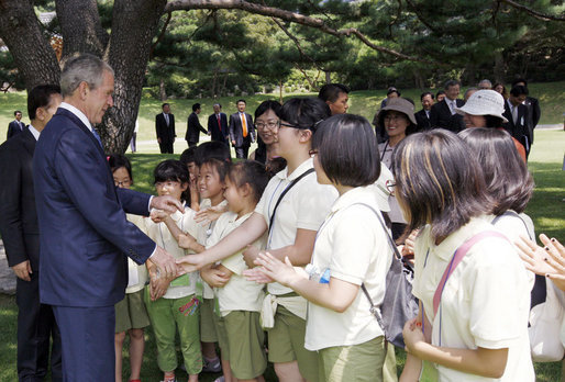 President George W. Bush is joined by South Korean President, Lee Myung-bak, as he greets children during his visit to the Blue House Wednesday, Aug. 6, 2008, in Seoul. White House photo by Eric Draper