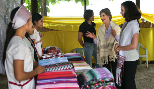 Mrs. Laura Bush and daughter Ms. Barbara Bush look over the weaving done by refugee women at the Mae La Refugee Camp at Mae Sot, Thailand, on Aug. 7, 2008. This traditional Karen craft helps the refugees make money and can be bought via the Internet through consortiums that work with the women in the camp which houses at least 39,000 Burmese. White House photo by Shealah Craighead