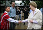 Mrs. Laura Bush is greeted as she prepares to enter a school at the Mae La Refugee Camp in Mae Sot, Thailand, where an English grammar class is being taught. Her Aug. 7, 2008 visit to the camp, which houses at least 39,000 Burmese refugees, highlighted the plight of a people who have struggled since the Aug. 8, 1988 crackdown that created dire conditions in their country 20 years ago. Many have moved to the United States or other countries such as Canada, New Zealand or the Netherlands. Mrs. Bush encouraged other countries to help the Burmese as well. White House photo by Shealah Craighead