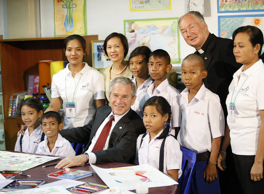 President George W. Bush poses for a photo with children and staff members, including Father Joseph Maier, during his visit Thursday, Aug. 7, 2008, to the Human Development Foundation-Mercy Centre, a non-profit organization to help educate and improve the health and welfare of poor children in Bangkok. White House photo by Eric Draper