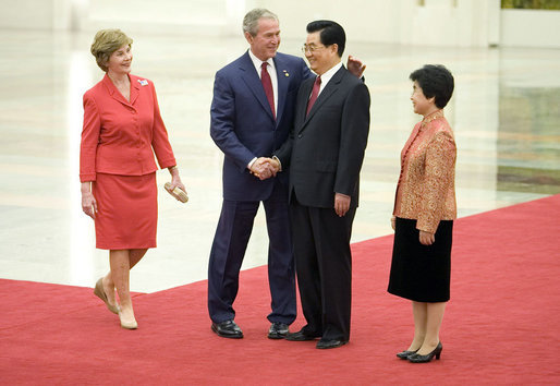 President George W. Bush and Mrs. Laura Bush are greeted by Chinese President Hu Jintao and Madam Liu Yongqing at the Great Hall of the People in Beijing Friday, Aug. 8, 2008, for the social lunch in honor of the 2008 Summer Olympic Games. White House photo by Eric Draper