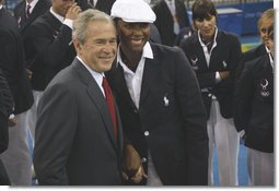 President George W. Bush stands with Danielle Scott-Arruda, a member of the U.S. Olympic Volleyball team, as he meets with the athletes Friday, Aug. 8, 2008, prior to the start of the Opening Ceremony of the 2008 Summer Olympic Games in Beijing. White House photo by Eric Draper