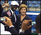 Mrs. Laura Bush with U.S. Flag Bearer Lopez Lomong as she greets members of the U.S. Summer Olympic Team at the Fencing Hall in Beijing on August 8, 2008. Mr. Lomong is a survivor of the violence in his native Sudan. He is now a U.S. citizen and was selected by his teammates to lead the U.S. Olympic team into the Olympic National Stadium carrying the United States Flag at the Opening Ceremony, which followed shortly after this picture was taken. White House photo by Shealah Craighead