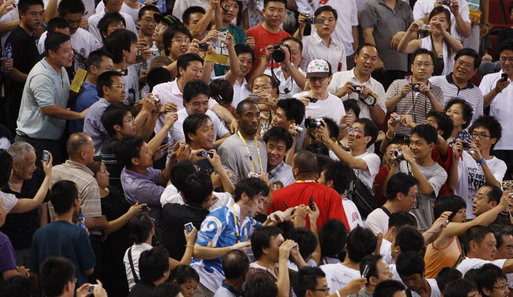 U.S. Olympic Men's Basketball Team member Kobe Bryant is surrounded by fans as he arrives to attend the U.S. Women's Olympic Basketball Team's match Saturday, Aug. 9, 2008, against the Czech Republic team at the Beijing 2008 Summer Olympics Games. White House photo by Eric Draper