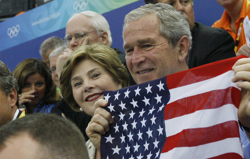President George W. Bush and Mrs. Laura Bush cheer on the U.S. Olympic swimmers during the Sunday morning competition at the National Aquatics Center in Beijing. White House photo by Eric Draper