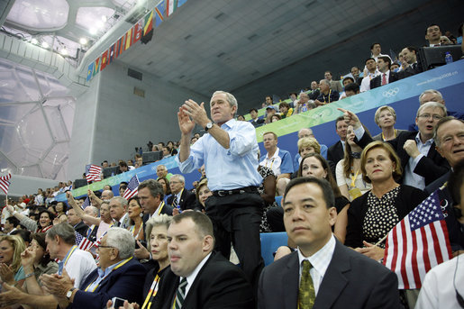 President George W. Bush whistles his support as Michael Phelps swims to his world-record mark in the 400-Meter Individual Medley Sunday, Aug. 10, 2008, at the 2008 Olympic Summer Olympics in Beijing. White House photo by Eric Draper