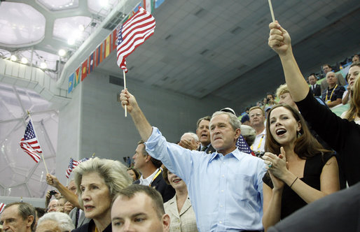 President George W. Bush, Mrs. Laura Bush and daughter Barbara Bush join the fans at the National Aquatics Center as they cheer on U.S. swimmer Michael Phelps as he swam his world-record setting 400-Meter Individual Medley event Sunday, Aug. 10, 2008, in Beijing. White House photo by Eric Draper