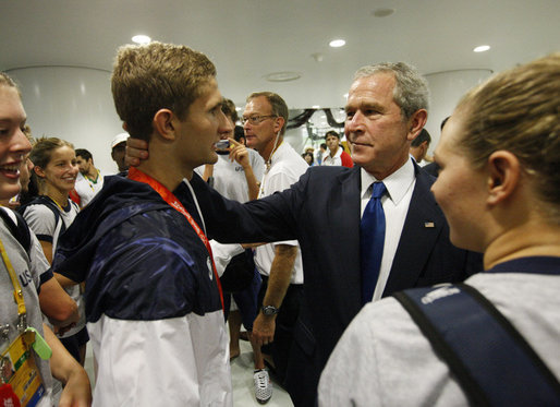 President George W. Bush speaks with U.S. Olympic swimmer and silver medalist Larsen Jensen Sunday, Aug. 10, 2008, at the National Aquatics Center in Beijing. White House photo by Eric Draper