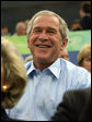 President George W. Bush smiles in response to the waves from the U.S. athletes after arriving Sunday, Aug. 10, 2008, at the National Aquatics Center in Beijing. White House photo by Shealah Craighead