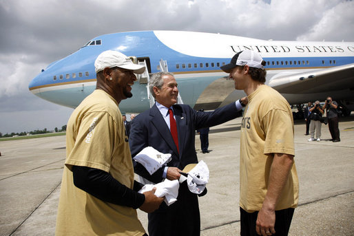 President George W. Bush is welcomed by New Orleans Saints running back Deuce McAllister, left, and Saints quarterback Drew Brees upon his arrival Wednesday, Aug. 20, 2008 to the Louis Armstrong International Airport in New Orleans. White House photo by Eric Draper