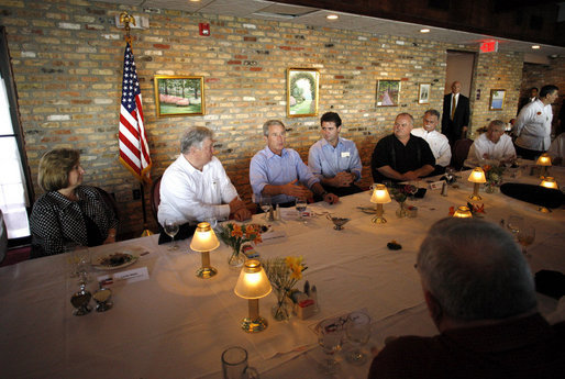 President George W. Bush is joined by Mississippi Governor Haley Barbour, second from left, and Gulfport, Miss., Mayor Brent Warr, right, Wednesday, Aug. 20, 2008 during a dinner with community leaders in Gulfport. Miss., to discuss the continued recovery efforts three years after Hurricane Katrina. White House photo by Eric Draper