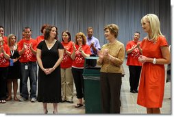 Mrs. Laura Bush and Mrs. Cindy McCain applaud the efforts of volunteers who are setting up a space in Minneapolis Convention Center Monday, September 1, 2008, to assemble and ship out care kits to support the victims of Hurricane Gustav.  White House photo by Shealah Craighead