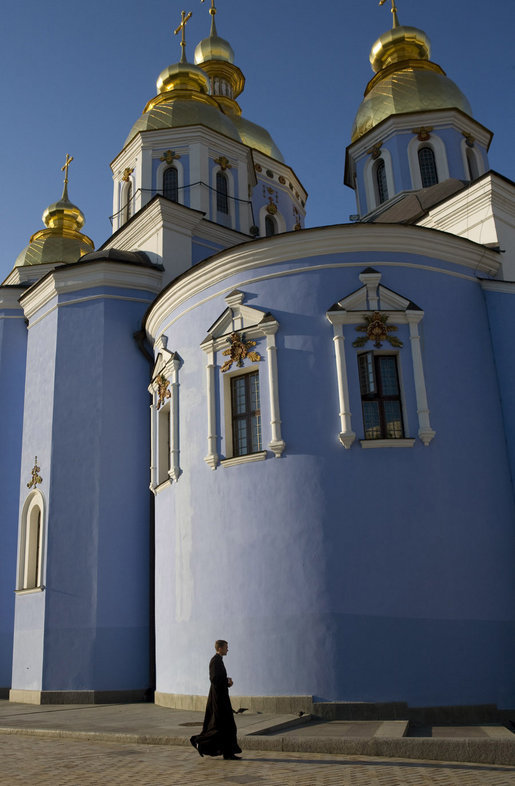 A member of the clergy walks past the gold-domed St. Michael's Monastery in the early morning light of Friday, Sept. 5, 2008 in Kyiv, where Vice President Dick Cheney is currently visiting during a multi-day tour of ex-Soviet republics. The monastery, originally constructed in the 12th century, is named after the Archangel Michael, patron saint of Kyiv, and was destroyed by Soviet communists between 1934-36 and reconstructed in 2000. White House photo by David Bohrer