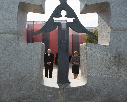 Seen through the Holodomor Memorial, Vice President Dick Cheney observes a moment of silence Friday, Sept. 5, 2008 in Kyiv, to remember the millions of Ukrainians murdered between 1932-33 during a Soviet enforced artificial famine. Mrs. Kateryna Yushchenko, wife of Ukrainian President Yushchenko, is at right. White House photo by David Bohrer