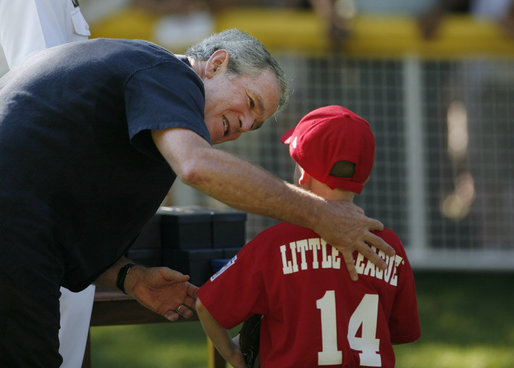 President George W. Bush presents a game ball to Stripes player Adam Plante, 6, of Burke, Va., following the Tee Ball on the South Lawn: A Salute to the Troops game Sunday, Sept. 7, 2008, played by the children of active-duty military personnel. White House photo by Andrew Hreha