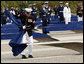 A Marine removes a ceremonial cloth during the unveiling of 184 memorial benches at the 9/11 Pentagon Memorial Thursday, Sept. 11, 2008, in Arlington, Va. White House photo by Eric Draper