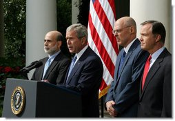 President George W. Bush stands with Federal Reserve Chairman Ben Bernanke, left, SEC Chairman Chris Cox, right, and Treasury Secretary Hank Paulson as he delivers a statement on the economy Friday, Sept. 19, 2008, in the Rose Garden of the White House. Said the President, "This is a pivotal moment for America's economy. We must act now to protect our nation's economic health from serious risk."  White House photo by Joyce N. Boghosian